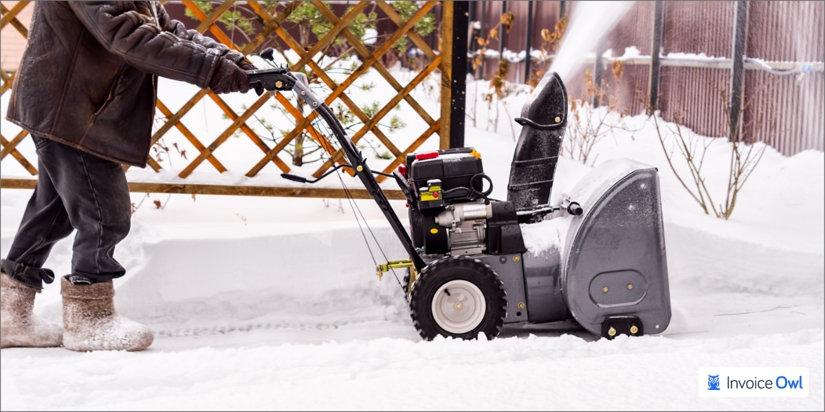 Landscaper providing snow removal services in winter